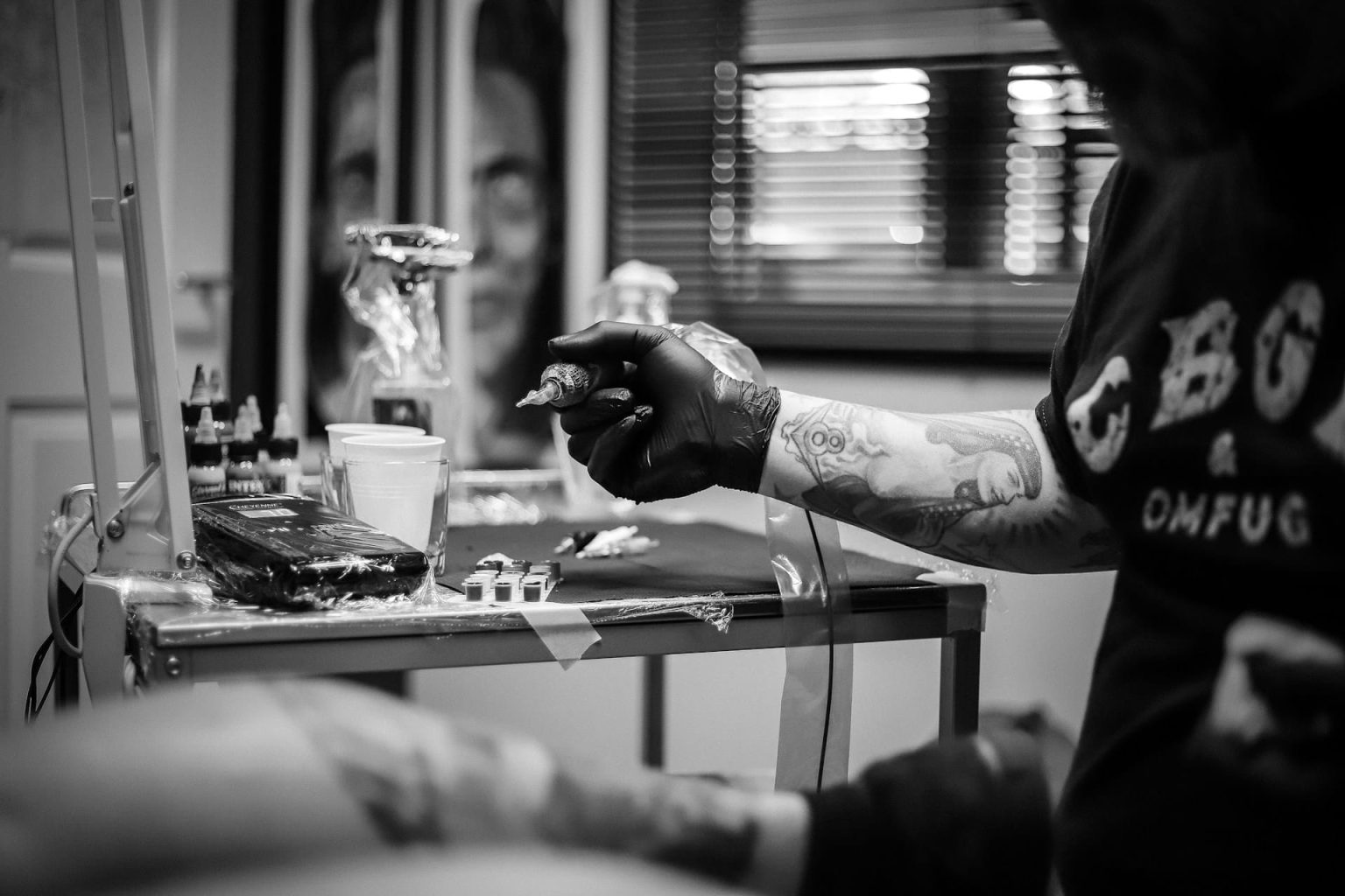 images of a guy doing a fine line tattoo in stockholm